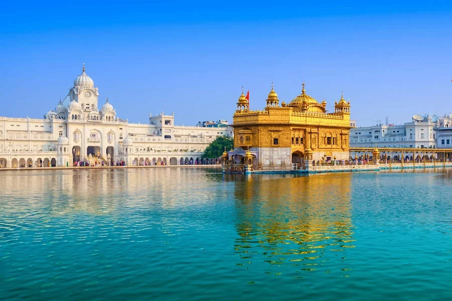 Golden Temple with blue sky and reflection on water, Amritsar, India.